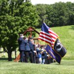 Uniformed vets saluting flag