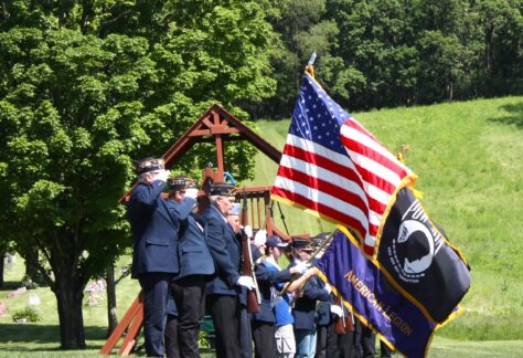 Uniformed vets saluting flag