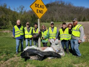 People standing with pile of garbage